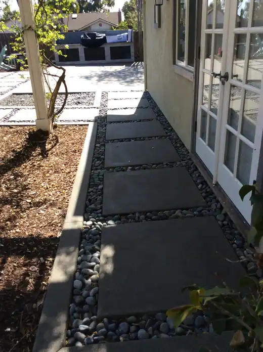 Stepping-stone slab walkway set with river rock
