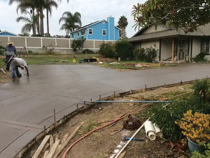 Crew finishing a curved driveway pour