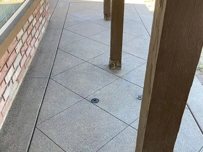 Exposed-aggregate patio under a pergola post